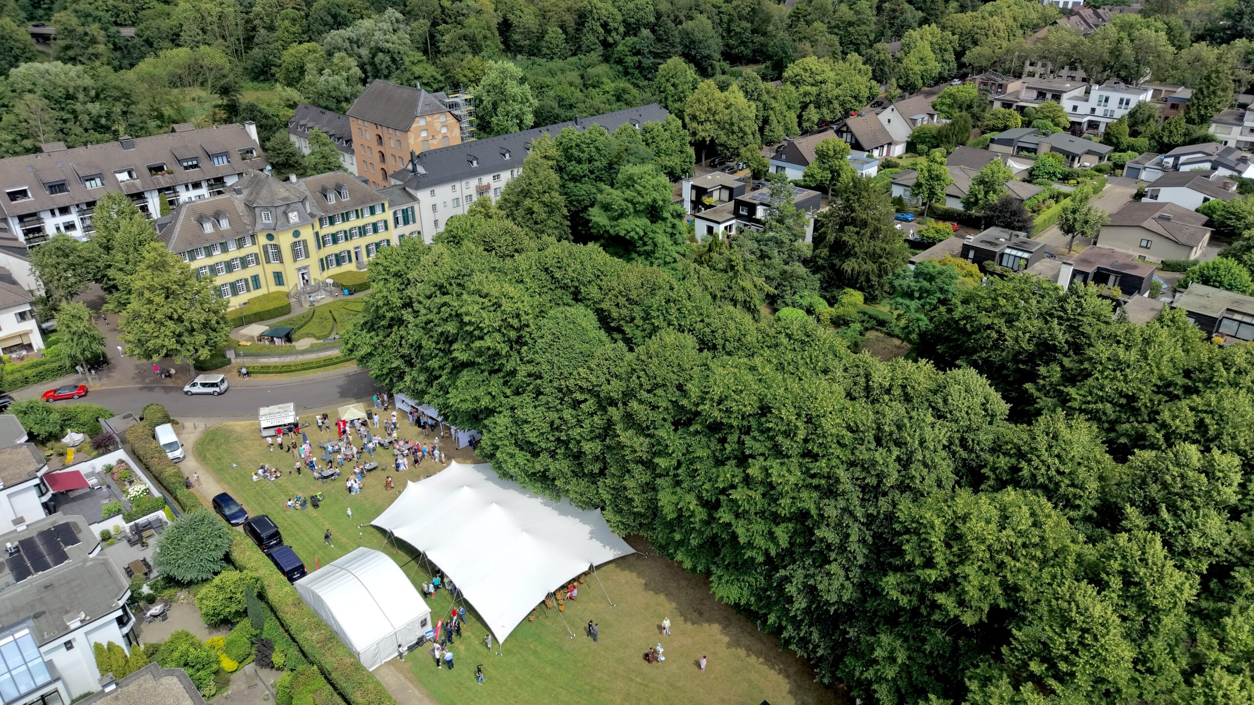 Festzelt mit Besuchern beim Parkfest am Herrenhaus Cromford in Ratingen, aufgenommen mit einer Drohne.